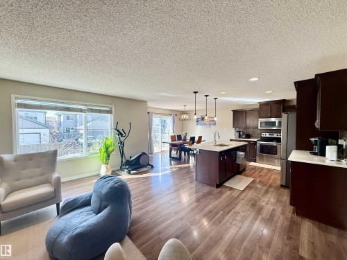 Open-concept main living area with wood-finish flooring - 3538 Claxton Crescent, Edmonton, AB - Indoor