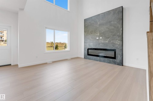 138 Creekside Lane Lane, Leduc, AB - Indoor Photo Showing Living Room With Fireplace