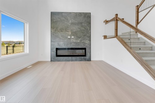 138 Creekside Lane Lane, Leduc, AB - Indoor Photo Showing Living Room With Fireplace