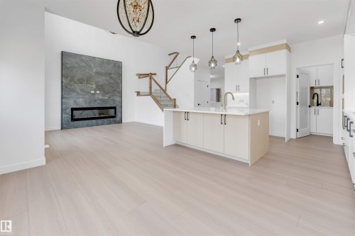 138 Creekside Lane Lane, Leduc, AB - Indoor Photo Showing Kitchen With Fireplace