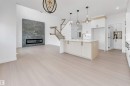 138 Creekside Lane Lane, Leduc, AB  - Indoor Photo Showing Kitchen With Fireplace 