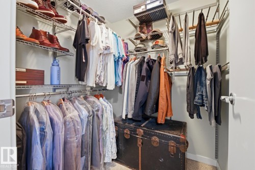 Customizable wire shelving system with multiple storage rods and overhead shelving - 304 4312 139 Ave, Edmonton, AB - Indoor With Storage