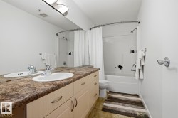 Bathroom featuring a double vanity with two oval sinks and a patterned countertop - 