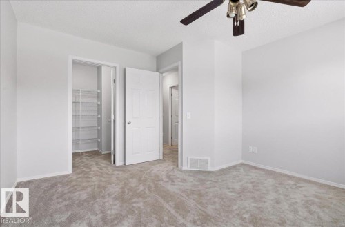 Carpeted interior space featuring light gray wall paint and white trim - #7 18004 89 St Nw, Edmonton, AB - Indoor Photo Showing Other Room