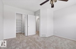 Carpeted interior space featuring light gray wall paint and white trim - 