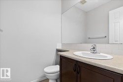 Vanity with an integrated oval sink, chrome faucet, and dark wood-finish cabinetry - 