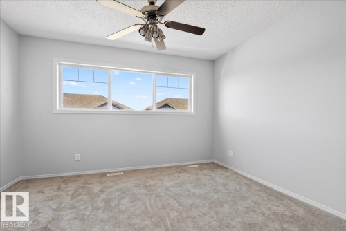 Spacious room featuring neutral carpeting and light-toned painted walls - #7 18004 89 St Nw, Edmonton, AB - Indoor Photo Showing Other Room