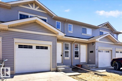 Modern townhome exterior featuring light gray horizontal siding, white trim, and multiple windows - #7 18004 89 St Nw, Edmonton, AB - Outdoor