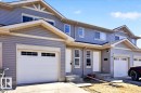 Modern townhome exterior featuring light gray horizontal siding, white trim, and multiple windows - #7 18004 89 St Nw, Edmonton, AB  - Outdoor 