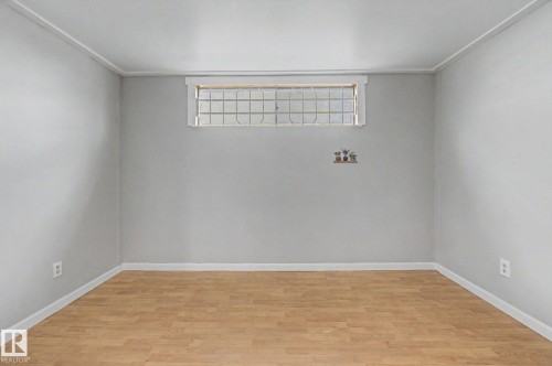 Room featuring wood-finish flooring, light gray walls, and white trim - 6048 105B Street, Edmonton, AB - Indoor Photo Showing Other Room