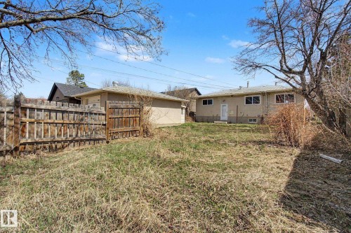 Expansive backyard with a detached garage, mature trees, and a privacy fence - 6048 105B Street, Edmonton, AB - Outdoor