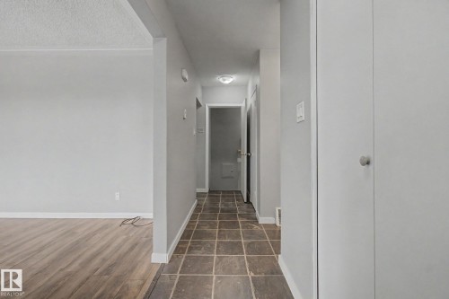 Hallway with square tile flooring and light grey walls - 6048 105B Street, Edmonton, AB - Indoor Photo Showing Other Room