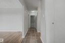 Hallway with square tile flooring and light grey walls - 6048 105B Street, Edmonton, AB  - Indoor Photo Showing Other Room 