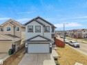 Two-story residence featuring light-colored siding with dark trim accents - 3247 15 Avenue Nw, Edmonton, AB 