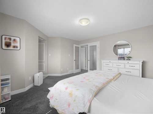 Neutral-toned interior featuring grey carpeting and white baseboards - 3247 15 Avenue Nw, Edmonton, AB 