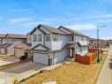 Two-story residence featuring light-colored siding and dark trim accents - 3247 15 Avenue Nw, Edmonton, AB 