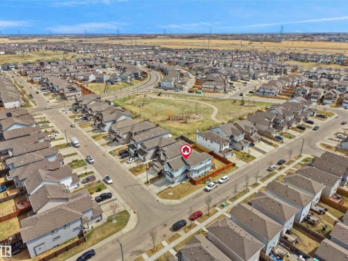 Aerial view showcasing a residential property with a light-colored exterior and a dark roof, positioned on a corner lot - 3247 15 Avenue Nw, Edmonton, AB 