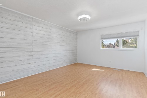 Accent wall featuring light wood plank detailing - 6734 36A Avenue, Edmonton, AB 