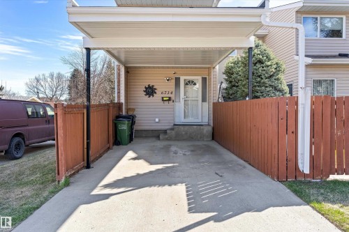 Two-story residence featuring light-colored siding and a covered carport - 6734 36A Avenue, Edmonton, AB 