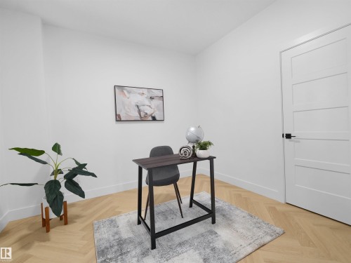 Light wood-finish flooring in a herringbone pattern - 209 Crystal Creek Dr Nw, Leduc, AB - Indoor