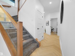 Contemporary staircase with wood-finish handrails and glass balusters - 