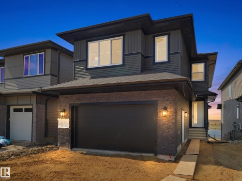Modern exterior featuring dark siding and stone accents - 209 Crystal Creek Dr Nw, Leduc, AB - Outdoor With Exterior