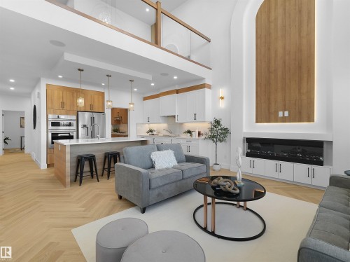 Open-concept living space featuring high ceilings and wood-finish flooring in a herringbone pattern - 209 Crystal Creek Dr Nw, Leduc, AB - Indoor Photo Showing Living Room