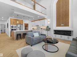 Open-concept living space featuring high ceilings and wood-finish flooring in a herringbone pattern - 