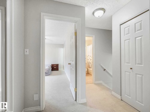 Carpeted hallway featuring white walls, white trim, and a flush-mount ceiling light - 4011 104 Street, Edmonton, AB - Indoor Photo Showing Other Room