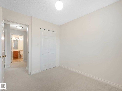 Bedroom with light-toned wall paint and carpet flooring - 4011 104 Street, Edmonton, AB - Indoor Photo Showing Other Room