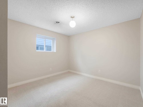 Bright room featuring light-toned carpeting, neutral wall paint, and white trim - 4011 104 Street, Edmonton, AB - Indoor Photo Showing Other Room