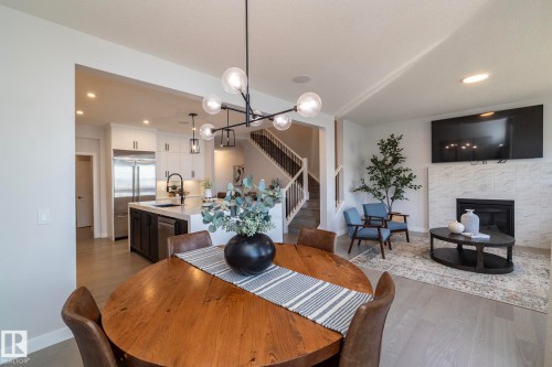 1448 Darby Green Green, Edmonton, AB - Indoor Photo Showing Dining Room With Fireplace