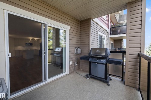 Private balcony featuring a concrete floor, horizontal siding, and a glass-paneled railing - 353 2096 Blackmud Creek Drive, Edmonton, AB - Outdoor With Exterior
