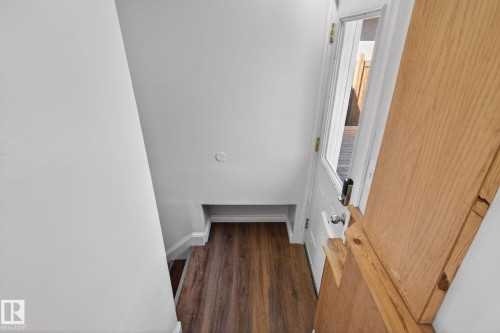Entryway featuring wood-finish flooring, white trim, and a white door with a clear glass panel - 10409 83 Street, Edmonton, AB - Indoor Photo Showing Other Room