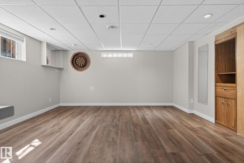 Spacious room featuring wood-finish flooring, recessed lighting, and a suspended ceiling - 10409 83 Street, Edmonton, AB - Indoor Photo Showing Other Room