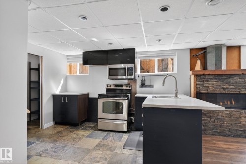 Kitchenette featuring a stainless steel appliance suite, modern cabinetry, and a countertop with an undermount sink - 10409 83 Street, Edmonton, AB - Indoor Photo Showing Kitchen