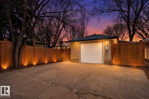 Detached garage with a white overhead door, complemented by a concrete driveway - 10409 83 Street, Edmonton, AB - Outdoor