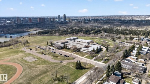 Aerial perspective highlighting a sprawling multi-building complex with extensive surrounding green space, including a track and fields - 10409 83 Street, Edmonton, AB - Outdoor With View