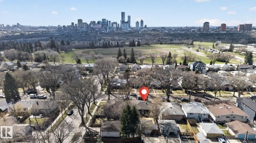 Suburban residential property with mature trees and a distant city skyline - 10409 83 Street, Edmonton, AB - Outdoor With View