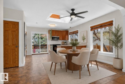 Open-concept living space with a vaulted ceiling and skylight - 10409 83 Street, Edmonton, AB - Indoor Photo Showing Dining Room