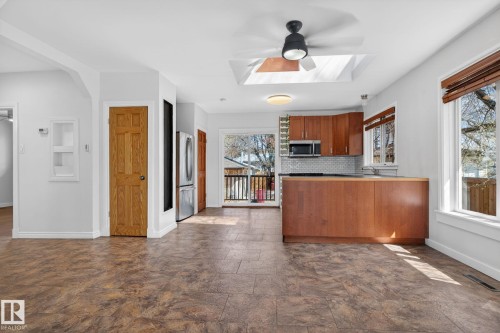 Open-concept living space with resilient flooring - 10409 83 Street, Edmonton, AB - Indoor Photo Showing Kitchen