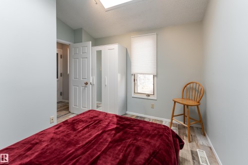 Main floor bedroom near back-entry, ideal for home office or guest suite. Vaulted ceiling with skylight - 10956 81 Avenue, Edmonton, AB - Indoor Photo Showing Bedroom