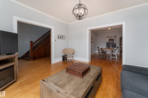 Bright and sunny living room with bay window and birch hardwood floors - 10956 81 Avenue, Edmonton, AB - Indoor Photo Showing Living Room