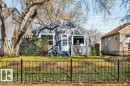 Front exterior featuring a decorative black metal fence and a manicured lawn - 11445 68 Street, Edmonton, AB  - Outdoor 