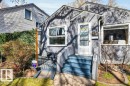 Gray stucco exterior featuring white trim, a front porch with blue-painted steps, and a white storm door - 11445 68 Street, Edmonton, AB  - Outdoor 