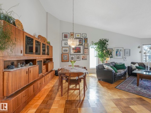 This spacious living area features high vaulted ceilings, parquet hardwood flooring, and a window providing natural light - 308 Beringer Crescent, Edmonton, AB - Indoor Photo Showing Living Room