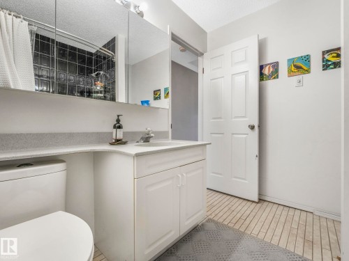 Bathroom featuring a white vanity with a light-colored countertop, a white toilet, and light-colored tiled flooring - 308 Beringer Crescent, Edmonton, AB - Indoor Photo Showing Bathroom