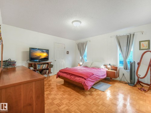This bedroom features a light parquet floor and light-colored walls - 308 Beringer Crescent, Edmonton, AB - Indoor Photo Showing Bedroom
