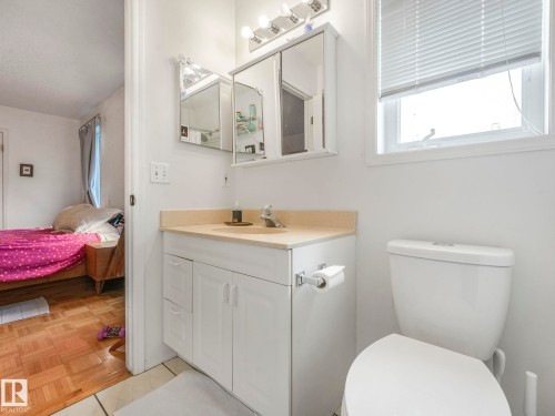 Bathroom featuring a white vanity with a light-colored countertop, a medicine cabinet, and a window with blinds - 308 Beringer Crescent, Edmonton, AB - Indoor Photo Showing Bathroom