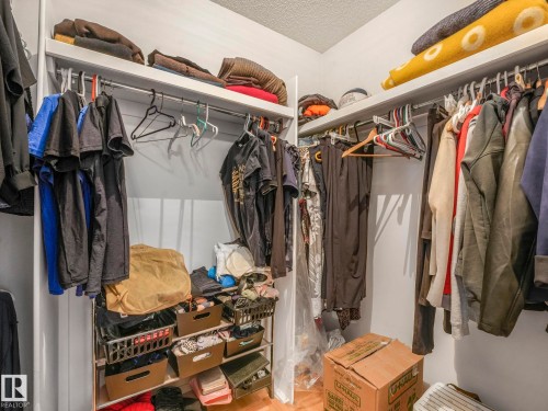 The property features a walk-in closet with white walls, upper shelving, and clothing rods providing ample storage - 308 Beringer Crescent, Edmonton, AB - Indoor With Storage